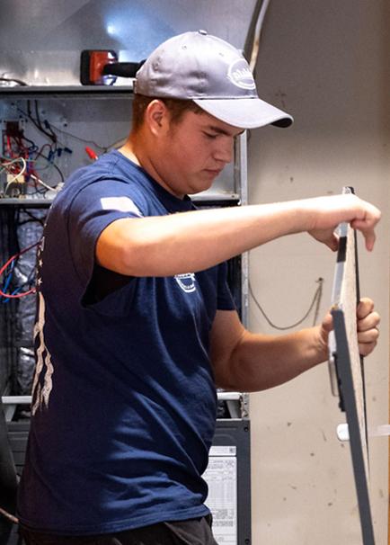 HVAC technician working on unit