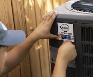 HVAC technician working on unit