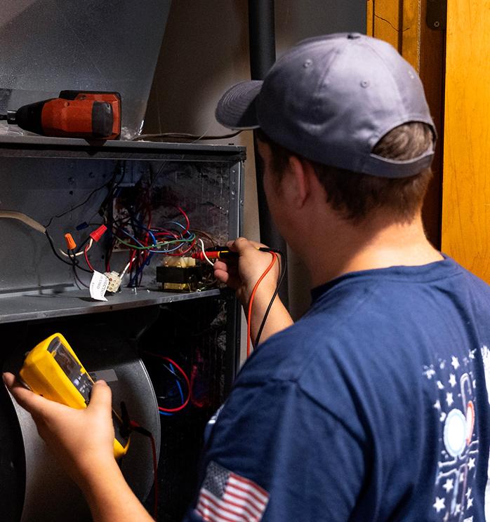 Technician fixing furnace