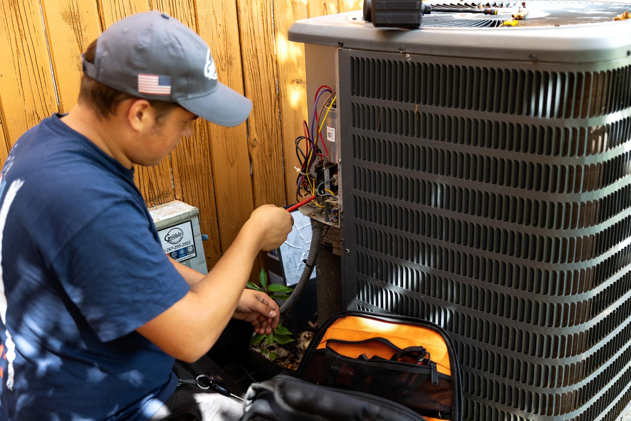 Technician fixing HVAC unit